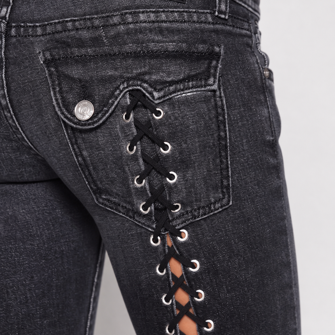 Lace-up jeans close-up showing back pocket area and existing lace detail in the dark water-washed denim for visual reference.