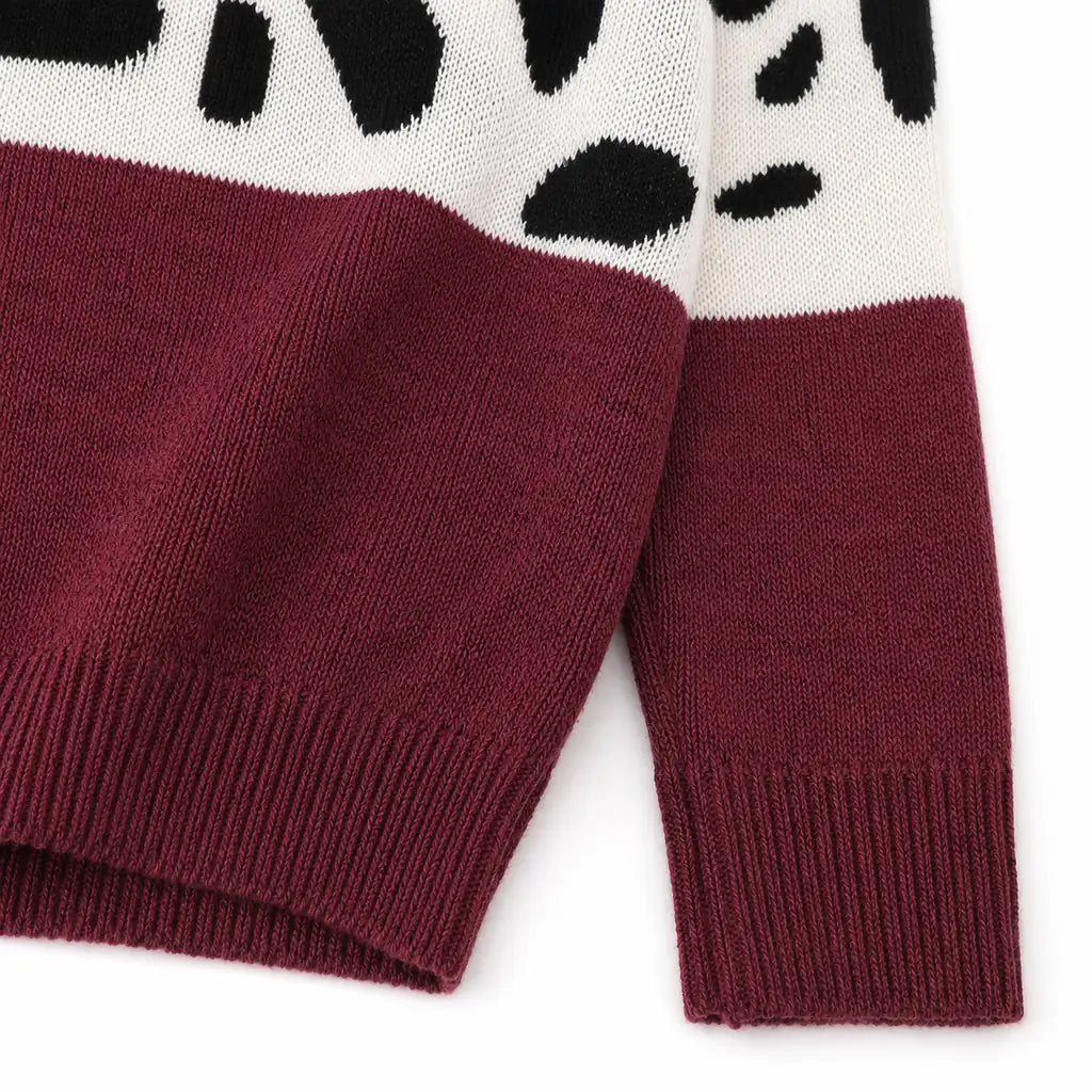 Close view of the Chestnut Red leopard print sweater knit texture, color-block transition, ribbed cuff and hem.