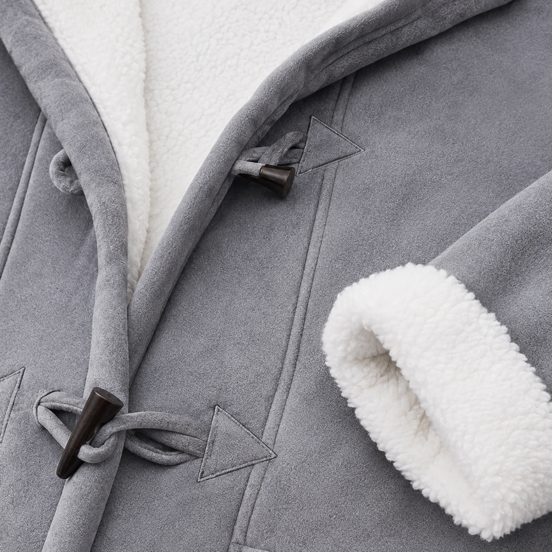 Grey sherpa lined toggle coat close-up showing fabric texture, seams, white lining, cuff finish and dark toggle closure details