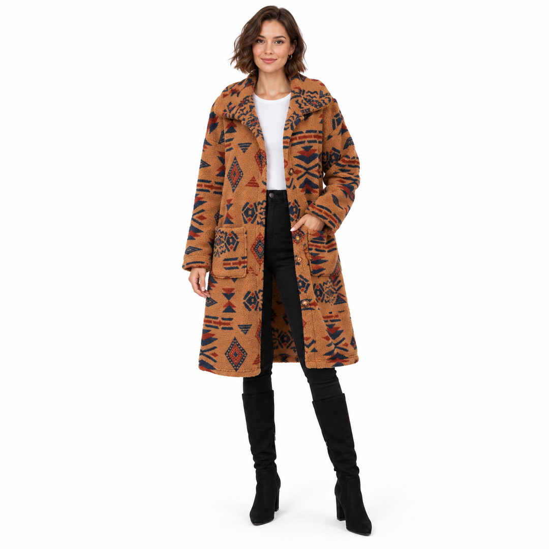 Full-length brunette model wearing the Camel coat with navy and rust geometric motifs.