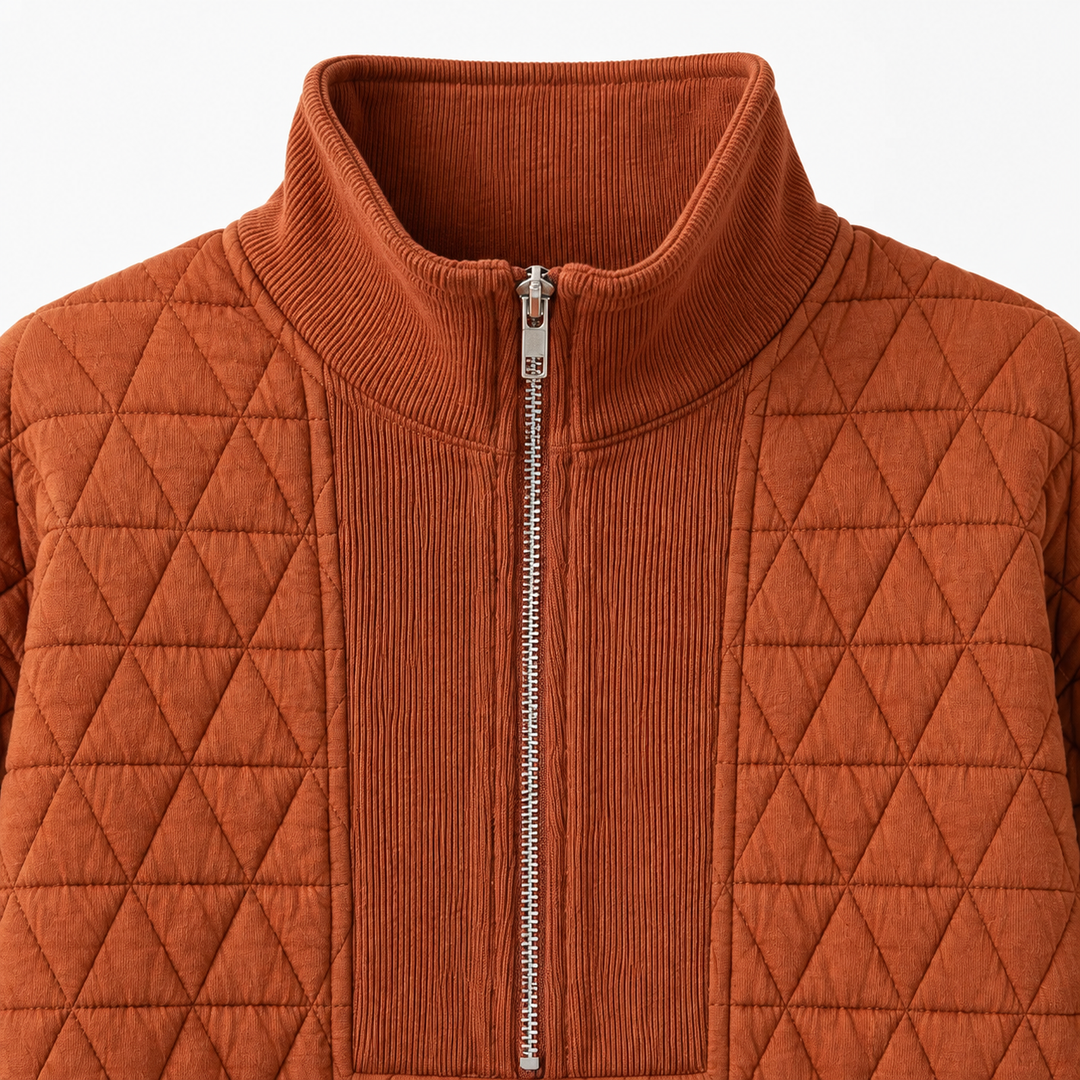 Close-up of the Caramel quilted sweatshirt showing the ribbed mock neck, silver half zipper, and geometric quilting.