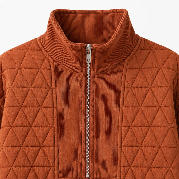 Close-up of the Caramel quilted sweatshirt showing the ribbed mock neck, silver half zipper, and geometric quilting.