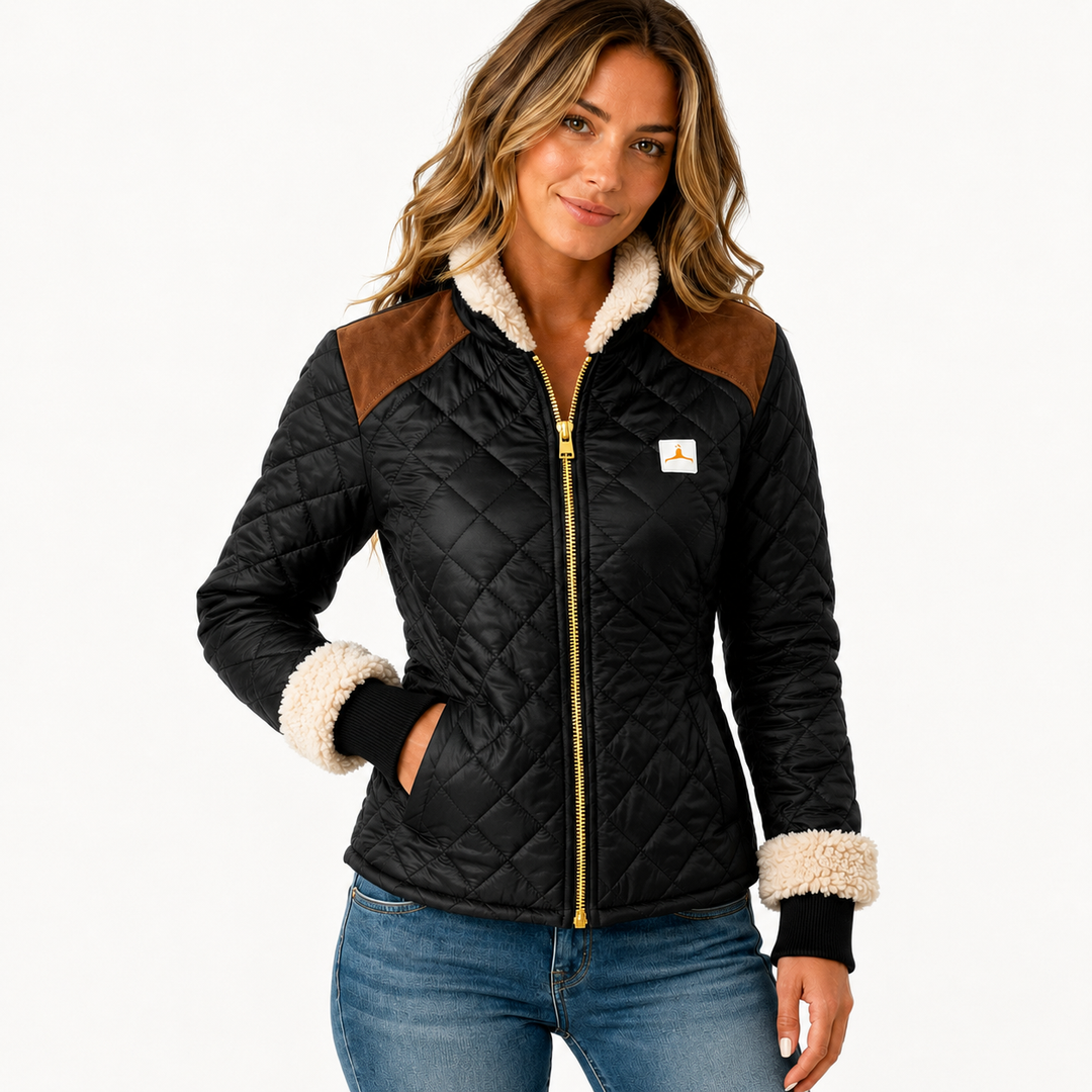 Commercial hero view of black quilted jacket on a model with cream trim, brown shoulder panels, diamond stitching and zipper.