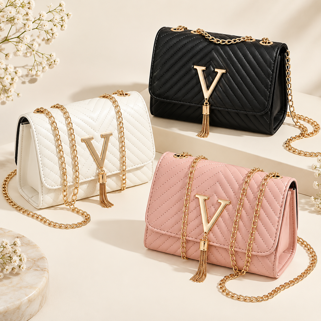 White, Black and Pink quilted shoulder bags arranged together with gold chain straps, V clasps and tassel details in studio.