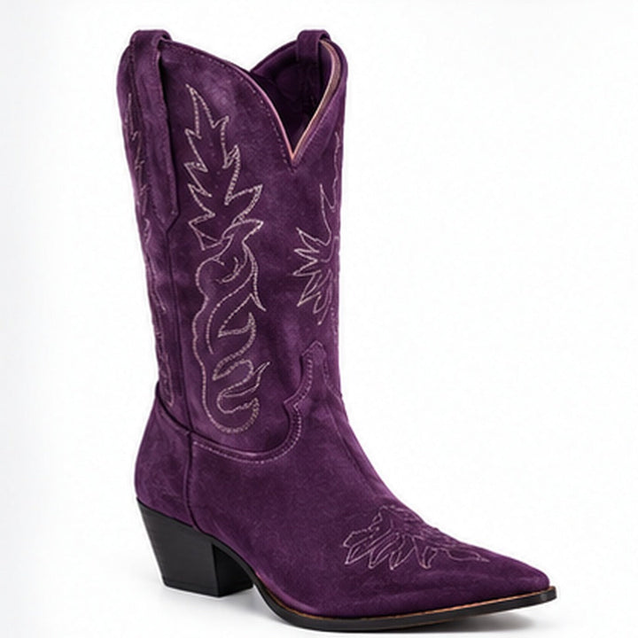 Purple V-cut suede boots with pointed toe and embroidered shaft on a clean white background.