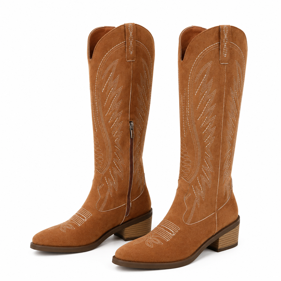 Brown V-cut western suede boots with embroidered knee-high shafts, side zippers and stacked square heels on white background.
