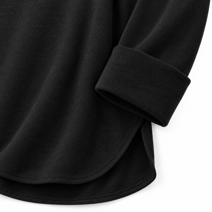 Close product view of the Black long sleeve top showing the cuff, hem and visible surface texture on a clean white background