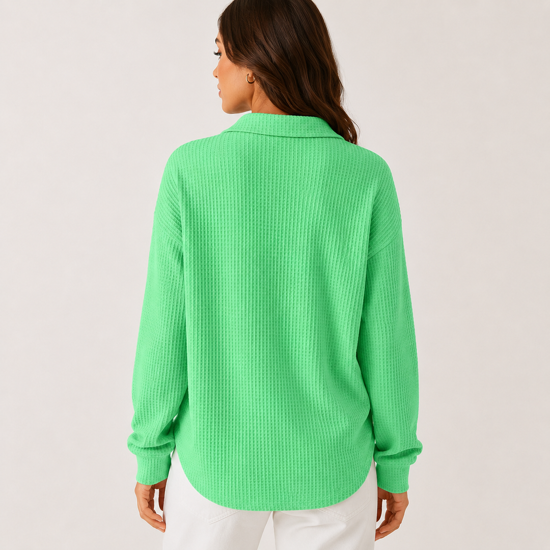Mint green long sleeve collared top shown from the back on a model showing a loose silhouette, waffle texture and curved hem.