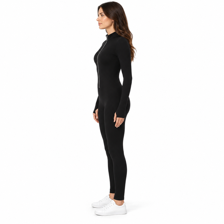 Side view of the black jumpsuit on an adult brunette model, showing a stand collar, long sleeves and fitted full-length legs.
